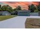 Charming single-story home showcasing a well-maintained lawn, an attached two-car garage, and mature trees at 2826 Martha Ln, Land O Lakes, FL 34639