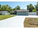 Charming single-story home features a two-car garage, well-maintained lawn, and mature trees at 2826 Martha Ln, Land O Lakes, FL 34639