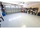 Spacious garage with epoxy flooring and storage shelves, offering ample space for vehicles and equipment at 2826 Martha Ln, Land O Lakes, FL 34639