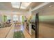 Modern kitchen featuring stainless steel appliances, skylight, and bright natural light for cooking and dining at 2826 Martha Ln, Land O Lakes, FL 34639