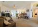 Spacious living room featuring a fireplace, neutral carpeting, and sliding glass doors to the outdoors at 2826 Martha Ln, Land O Lakes, FL 34639