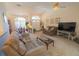 Inviting living room featuring a large window for natural light and seamless transition to dining space at 2826 Martha Ln, Land O Lakes, FL 34639