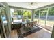 Enclosed patio with tile floor, ceiling fan, furniture, and views of the fenced backyard at 2826 Martha Ln, Land O Lakes, FL 34639