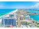 Stunning aerial view of a bustling city with pristine beaches, a scenic pier, and sparkling ocean waters at 301 S Gulfview Blvd # 301, Clearwater Beach, FL 33767