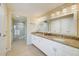 Bathroom featuring granite countertops, dual sinks, and glass shower at 301 S Gulfview Blvd # 301, Clearwater Beach, FL 33767