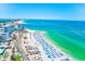 Beautiful aerial view of sandy beach, turquoise waters, beachfront hotels, and bustling coastal scenery at 301 S Gulfview Blvd # 301, Clearwater Beach, FL 33767