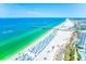 Expansive beach view highlighting the pier, white sand, crystal ocean, and clear blue skies perfect for relaxation at 301 S Gulfview Blvd # 301, Clearwater Beach, FL 33767
