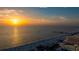Stunning aerial view of the ocean with the sun setting on the horizon at 301 S Gulfview Blvd # 301, Clearwater Beach, FL 33767