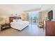 Serene bedroom with tray ceiling and balcony access offering serene views at 301 S Gulfview Blvd # 301, Clearwater Beach, FL 33767