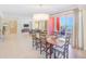 Bright dining area with coastal decor chandelier, balcony access, and views of the ocean at 301 S Gulfview Blvd # 301, Clearwater Beach, FL 33767