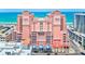 Stunning view of the pink beachfront condo with balconies and ocean view at 301 S Gulfview Blvd # 301, Clearwater Beach, FL 33767