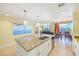 Spacious kitchen with granite countertops and open layout flowing into the dining and living areas at 301 S Gulfview Blvd # 301, Clearwater Beach, FL 33767