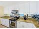 Kitchen showcasing sleek stainless steel appliances and granite countertops at 301 S Gulfview Blvd # 301, Clearwater Beach, FL 33767