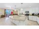 Open kitchen with a large island, granite countertops, and views of the ocean from dining area at 301 S Gulfview Blvd # 301, Clearwater Beach, FL 33767
