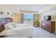 Bright main bedroom boasts a balcony, tile flooring and a decorative headboard at 301 S Gulfview Blvd # 301, Clearwater Beach, FL 33767