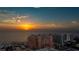 Spectacular sunset view over the ocean with buildings and beach below for a tranquil living experience at 301 S Gulfview Blvd # 301, Clearwater Beach, FL 33767