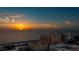 Stunning sunset view overlooking the ocean, sandy beach and nearby buildings, showcasing serene coastal charm at 301 S Gulfview Blvd # 301, Clearwater Beach, FL 33767