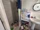 Bathroom includes a tiled shower with curtain and a sink with storage. Needs TLC at 314 Dickman Sw Dr, Ruskin, FL 33570