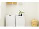 Bright laundry area with white washer and dryer, complementing the neutral decor and providing a clean, functional space at 31814 Griffin Sands Ln, San Antonio, FL 33576