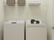 Functional laundry room with a modern washer and dryer at 31856 Griffin Sands Ln, San Antonio, FL 33576
