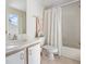 Well-lit bathroom with a shower/tub combo, white tile, and a vanity sink offers a clean and functional space at 320 Island Way # 205, Clearwater Beach, FL 33767