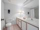 Bright bathroom featuring a white vanity, tile floors, and a large mirror at 320 Island Way # 205, Clearwater Beach, FL 33767