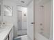 Bathroom with a white tub and shower with a white tile surround and white vanity at 320 Island Way # 205, Clearwater Beach, FL 33767