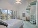 Bedroom features a bed, ceiling fan, and sliding glass door leading to a balcony, plus a unique spiral staircase at 320 Island Way # 205, Clearwater Beach, FL 33767