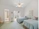 This bedroom boasts two beds, a ceiling fan, a sliding door, and an adjacent bathroom for added convenience at 320 Island Way # 205, Clearwater Beach, FL 33767