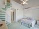 The bedroom features a bed, ceiling fan, spiral staircase, and plenty of natural light at 320 Island Way # 205, Clearwater Beach, FL 33767