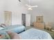 The bedroom features two beds, a ceiling fan, and a dresser for storage at 320 Island Way # 205, Clearwater Beach, FL 33767