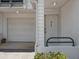Unit entrance with adjacent garage and well-maintained landscaping at 320 Island Way # 205, Clearwater Beach, FL 33767