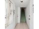 Bright entryway with tile flooring and a staircase leading to the upper level at 320 Island Way # 205, Clearwater Beach, FL 33767