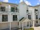 Charming condo featuring a white exterior, dual balconies, and convenient garage access at 320 Island Way # 205, Clearwater Beach, FL 33767