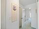 Hallway leading upstairs with a framed piece of artwork and a door on the left at 320 Island Way # 205, Clearwater Beach, FL 33767
