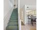 Second floor hallway with a staircase and a view of the bright kitchen with breakfast bar at 320 Island Way # 205, Clearwater Beach, FL 33767