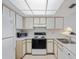 Functional kitchen featuring white appliances and plenty of cabinet space at 320 Island Way # 205, Clearwater Beach, FL 33767
