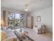 A bright living room featuring a ceiling fan and sliding glass doors to the charming balcony at 320 Island Way # 205, Clearwater Beach, FL 33767