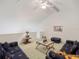 Carpeted living room featuring vaulted ceilings, a ceiling fan, and sofas at 320 Island Way # 205, Clearwater Beach, FL 33767