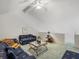 Living room featuring vaulted ceilings, a ceiling fan, and sofas at 320 Island Way # 205, Clearwater Beach, FL 33767