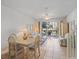 Bright living room featuring a dining area and sliding glass doors to a charming outdoor balcony at 320 Island Way # 205, Clearwater Beach, FL 33767