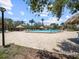 Community pool with plenty of lounge chairs and tiki umbrellas surrounded by meticulously maintained landscaping at 320 Island Way # 205, Clearwater Beach, FL 33767