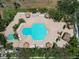 Aerial view of pool area and spa with palm trees and many seating options at 320 Island Way # 205, Clearwater Beach, FL 33767
