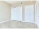 Neutral-toned bedroom features tile flooring, closet with sliding doors, and white trim at 345 Bayshore Blvd # 1813, Tampa, FL 33606