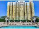 Exterior view of high-rise building with pool and lush tropical landscaping at 345 Bayshore Blvd # 1813, Tampa, FL 33606