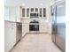 Modern kitchen with stainless steel appliances, white cabinetry, and tiled floors at 345 Bayshore Blvd # 1813, Tampa, FL 33606