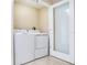 Laundry room with a white washer and dryer and glass door at 345 Bayshore Blvd # 1813, Tampa, FL 33606