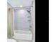 Shower with gray tile surround, rainfall shower head, and glass shelving at 345 Bayshore Blvd # 1813, Tampa, FL 33606