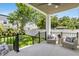 Relaxing back porch with comfortable seating, ceiling fan, and a view of the lush, green backyard at 3616 W Anderson Ave, Tampa, FL 33611