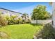 Lush backyard with privacy fence, well-manicured lawn and tropical landscaping at 3616 W Anderson Ave, Tampa, FL 33611